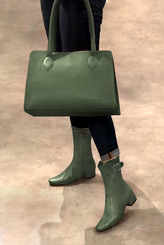 Women's forest green elegant ankle boots, with buckles on the sides. Round toe. Low block heels - Worn view